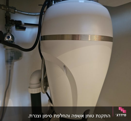 מתקן טוחן אשפה מתחת לכיור עם צינורות חיבור